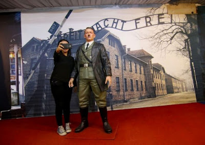 Ignorance: An Indonesian woman take a selfie with a life-size wax sculpture of Adolf Hitler at a museum in Yogyakarta.