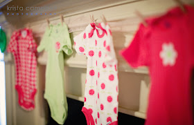 onesies hanging up, clothespins, onesie decor, baby shower decor ideas