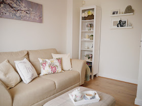 SBefore and after pictures showing how we transformed our dingy, small brightly-coloured lounge into a bright and airy living room using neutral coloured paint and accessories 