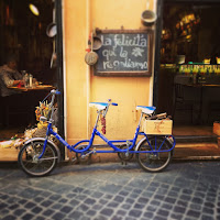 Double bike parked outside one of Rome's quaint lunch spots, Rome, Lazio, Italy