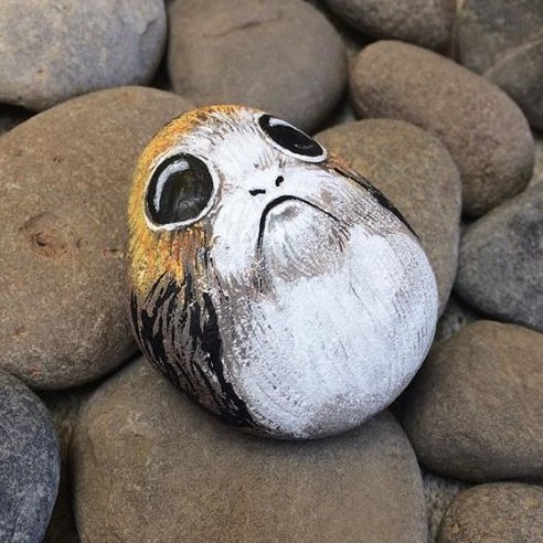 painted stone painted to look like a mini porg