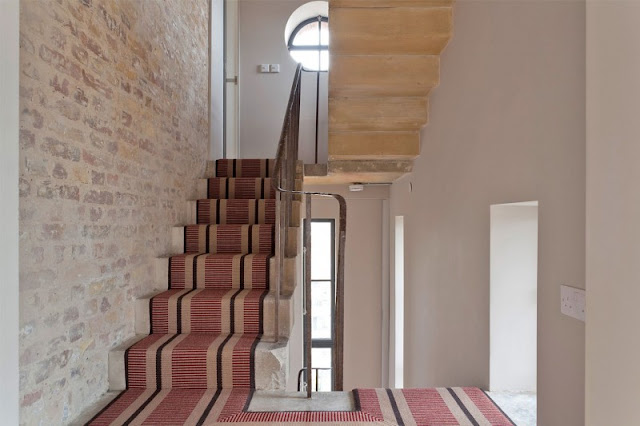 Pictured of wooden stairs and red carpet in the water tower