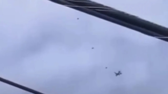Jet airplane with 3 UFOs next to it flying in formation.