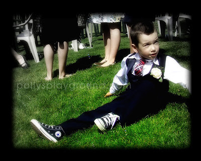 ring bearer sitting in grass