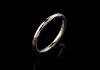 plain wedding band on black background