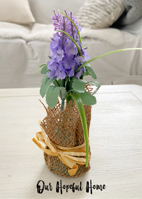 burlap wrapped small purple faux flower arrangement