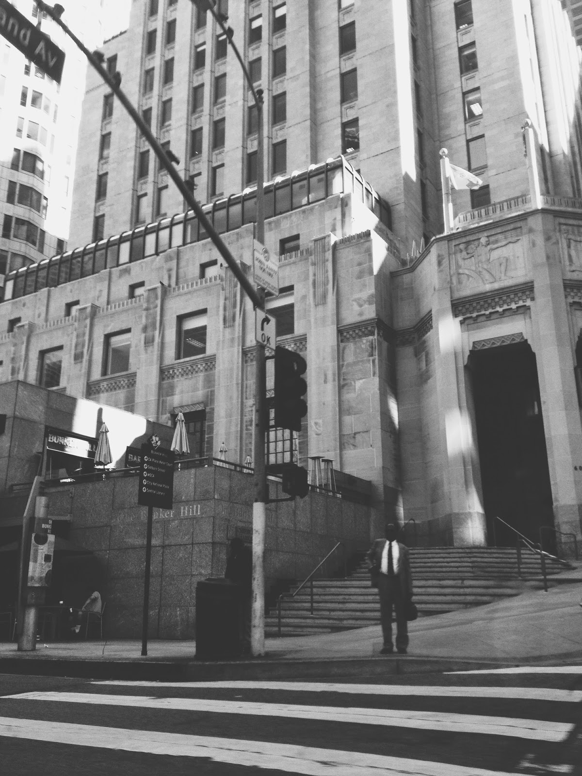 man standing at crosswalk of Bunker Hill Los Angeles