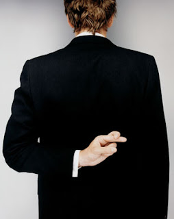 photo image of a person on a suit from behind. the person is making a hand gesture indicating that it is uttering a lie. 