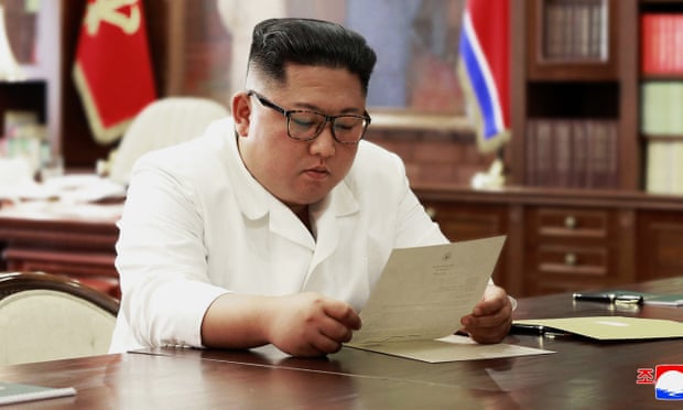 Kim Jong-un reads a letter from Donald Trump