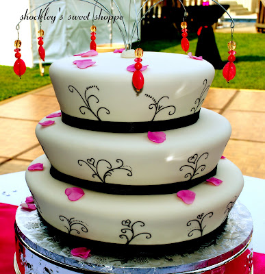 A 3tier 101214 drumshaped round wedding cake adorned with Fuschia