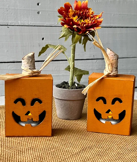 Photo of Dollar Tree painted/upcycled Jack O' Lantern boxes with tealight LED candles.