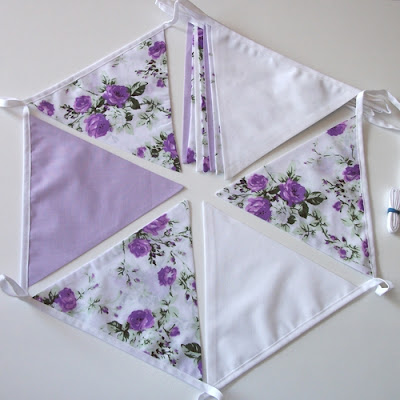 purple roses with lilac and white bunting