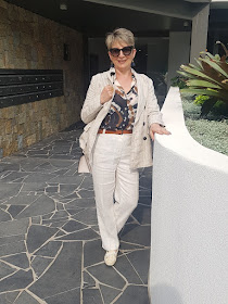 Thinking of Italy:  tan colour linen pants a blazer with multi-coloured blouse and a pair of loafers