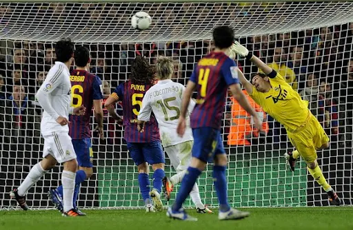 Real Madrid goalkeeper Iker Casillas fails to stop a goal from Barcelona player Daniel Alves