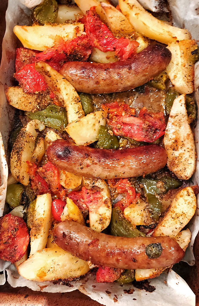 a pan of sausage, peppers, tomatoes and potatoes