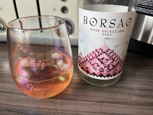 Empty bottle of Borsao rose wine with a glass
