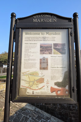 A picture of a sign with information and illustrations for visitors to the town.