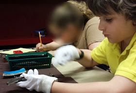 Week 18: In your (their) hands ~ William handling Egyptian artifacts at the ROM :: All Pretty Things