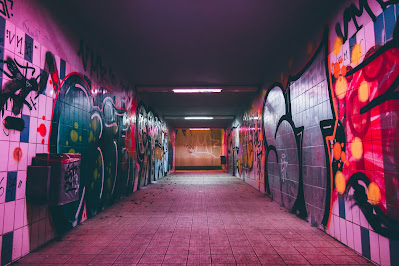 A darkened hallway with graffiti covering the walls in pink and purple tones. Photo by <a href="https://unsplash.com/@hinbong?utm_source=unsplash&utm_medium=referral&utm_content=creditCopyText">Hin Bong Yeung</a> on <a href="https://unsplash.com/wallpapers/art/graffiti?utm_source=unsplash&utm_medium=referral&utm_content=creditCopyText">Unsplash</a>