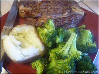 grilled rib steak with baked potato and steamed broccoli