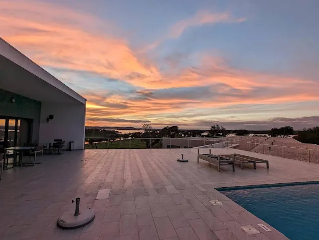 Sunset over the pool at Herdade dos Delgados on Lake Alqueva in Alentejo Portugal