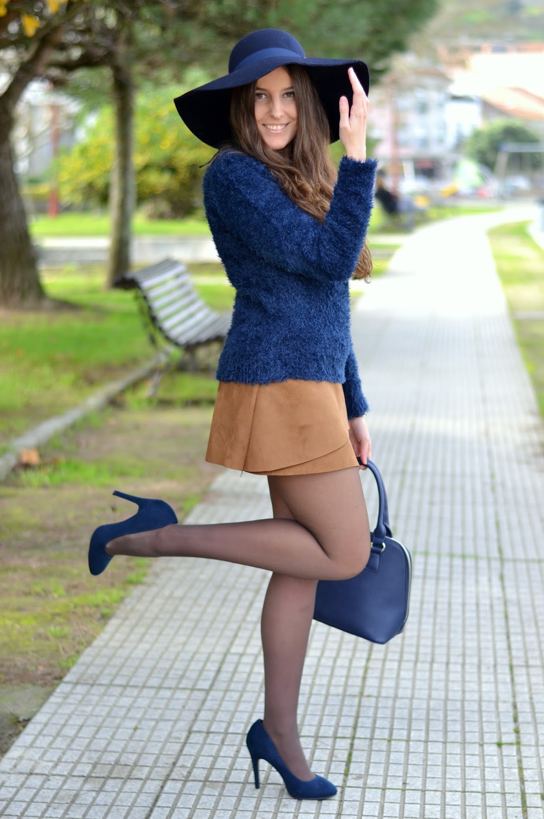 blue hat and sweater with brown skirt