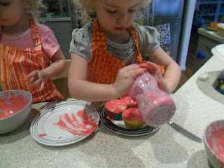 Decorating the cupcakes with sprinkles