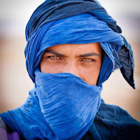 A portrait of a Taureg man with his face mostly covered.