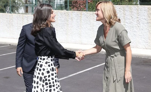 Queen Letizia and Kate Middleton wore a same two-tone skirt by Massimo Dutti. Letizia wore a v-neck silk shirt by Sandro