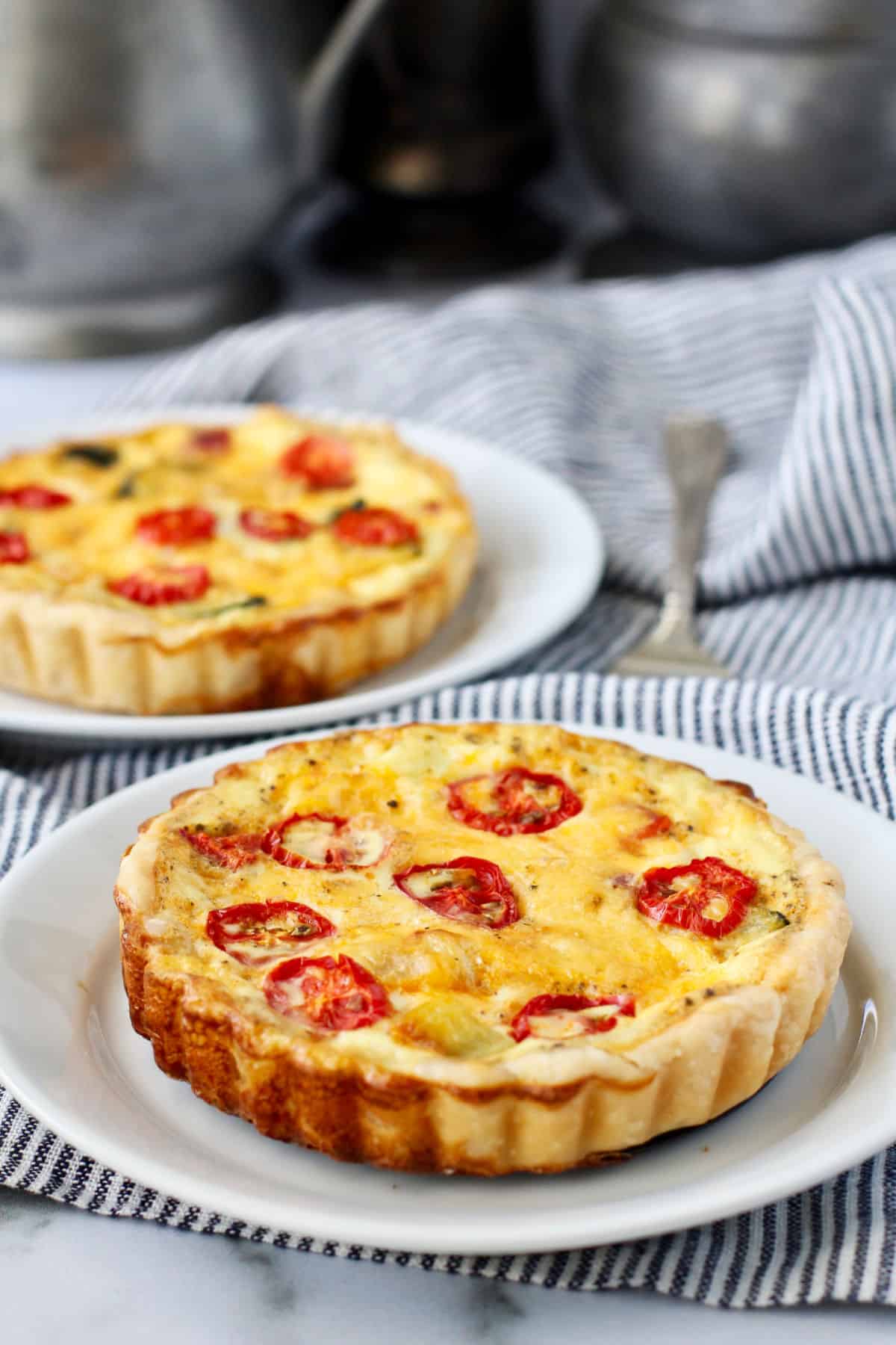Vegetable and Cheddar Tarts on two plates.