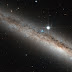 A spiral galaxy crowned by a star