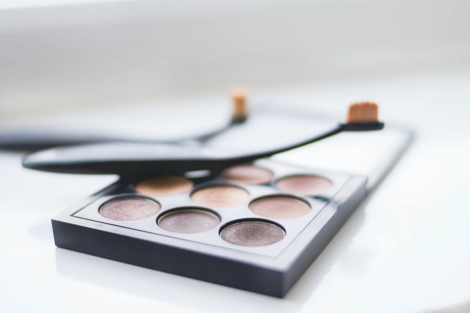 a close-up of a makeup palette on a plain background