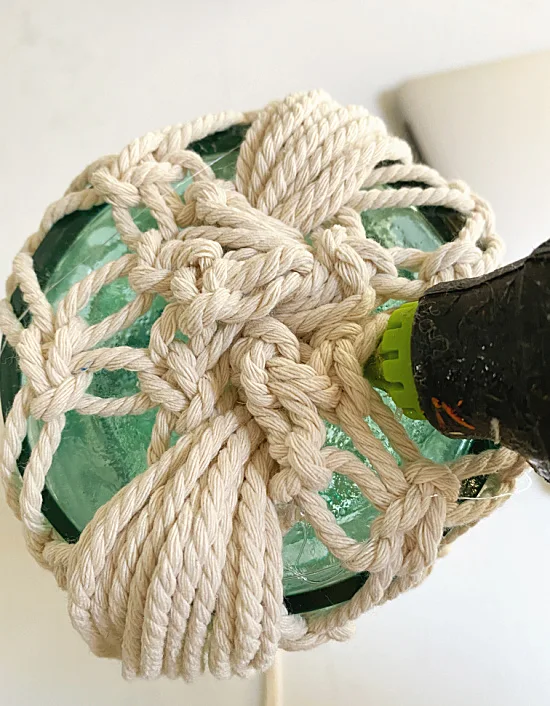 hot gluing knot at bottom of vase