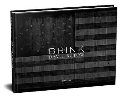 photograph of the cover of the David Butow book "Brink" showing title printed over black and white American flag