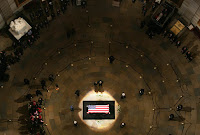 President George W. Bush and Mrs. Laura Bush stand at the side of his flag-draped coffin as they pay their respects to the late President Gerald R. Ford Monday, Jan. 1, 2007, in the Rotunda of the U.S. Capitol. White House photo by Shealah Craighead.