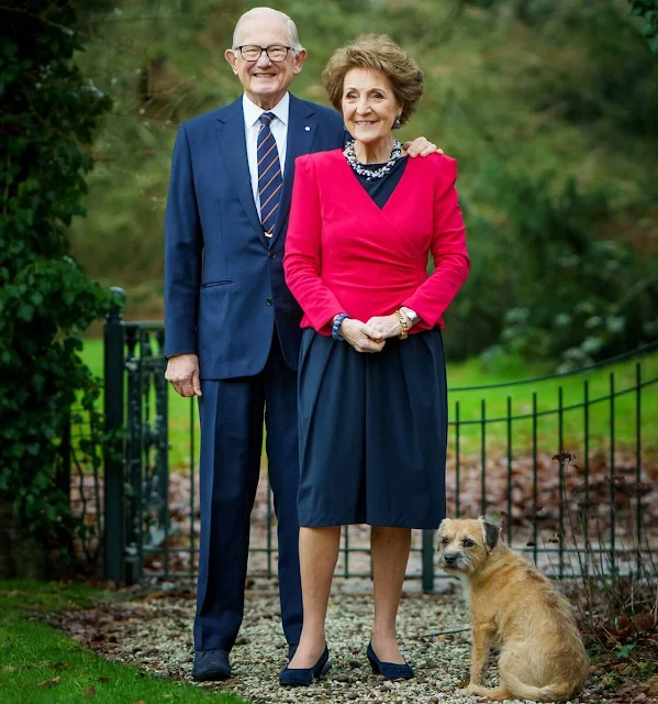 Princess Margriet wore a red cashmere cardigan, and navy blue midi dress. Diamond earrings and stone necklace