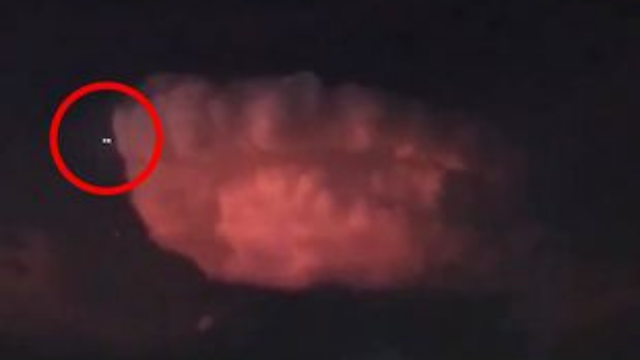 UFO circled in red comes around the red looking cloud.