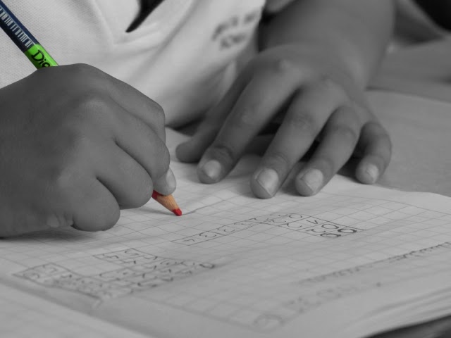 student hand holding a pen