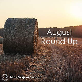 a round straw bale standing in a stubble field surrounded by other bales in a setting sun sky