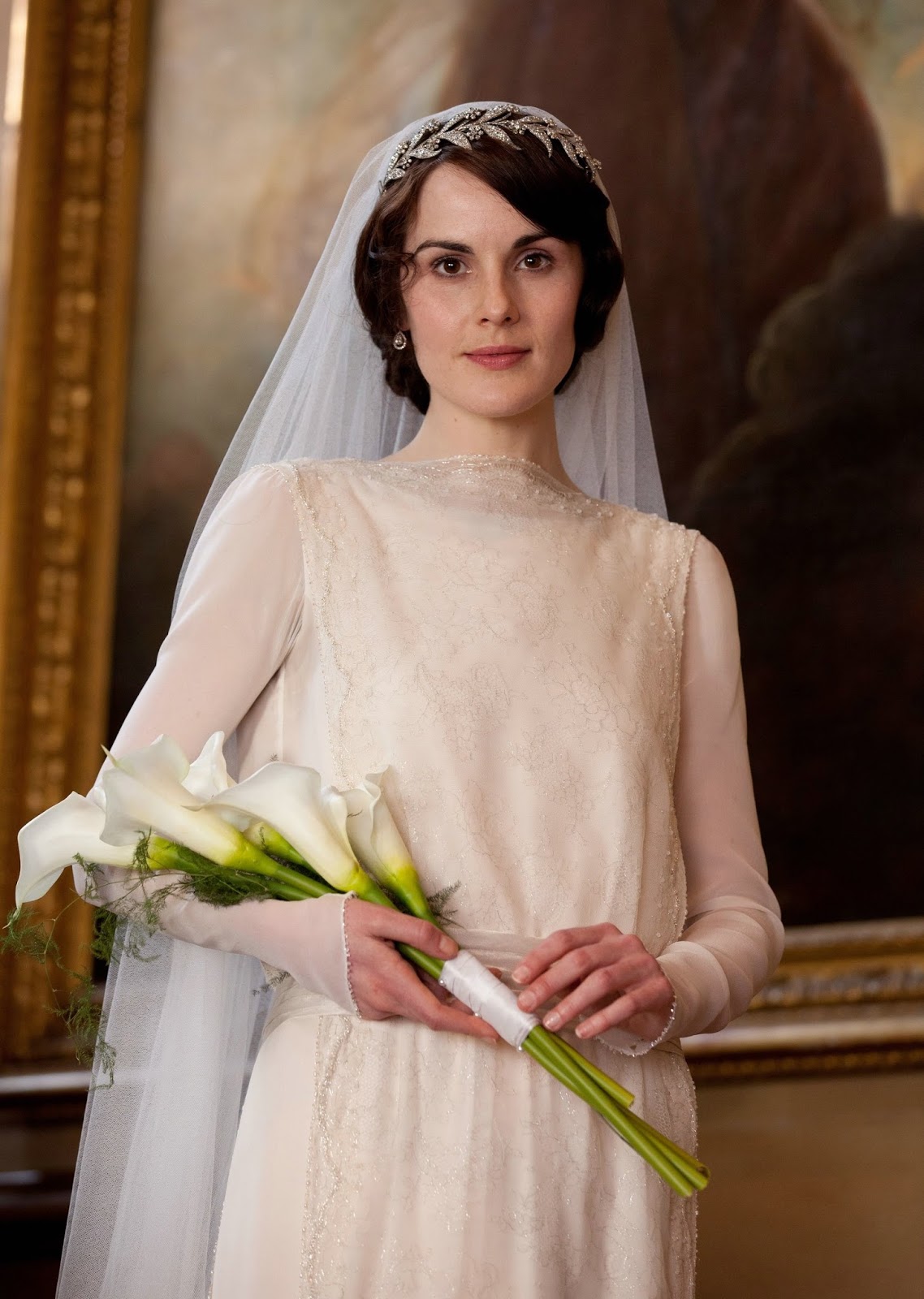 vintage wedding dresses with sleeves and lace  ,sheer long sleeves and column shape.And the headpiece and long veil