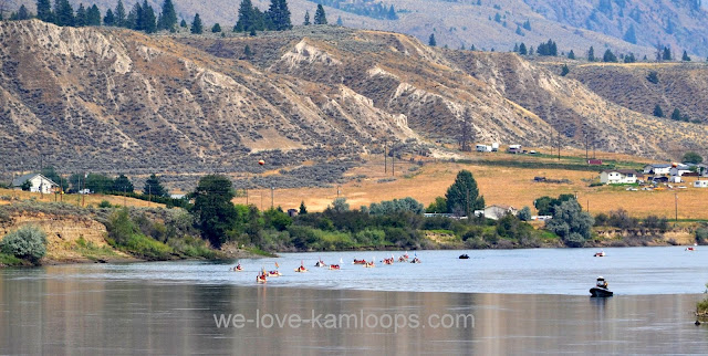 Several canoes can now be seen as they come around the corner in the river