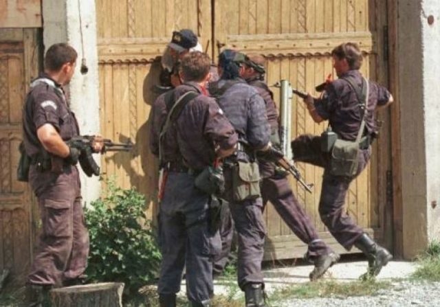 Serbian soldiers entering by force in an Albanain house