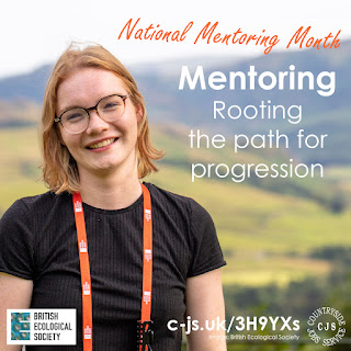 A smiling person in a black tshirt with an orange lanyard round their neck. Text reads: National Mentoring Month - mentoring - rooting the path for progression