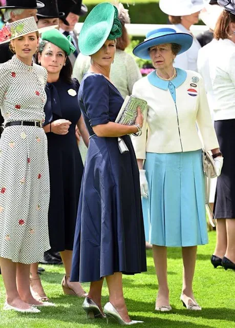 Zara Tindall wore a blue dress by Laura Green. Queen Camilla wore her Anna Valentine pink dress coat. Suzannah Allison dress