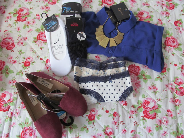 Burgundy loafers, white and black socks, royal blue chiffon shift and gold/brass necklace on floral quilt