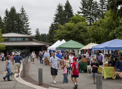 Wide shot of Oregon campus Fun Day tents and people walking with their kids and puppies