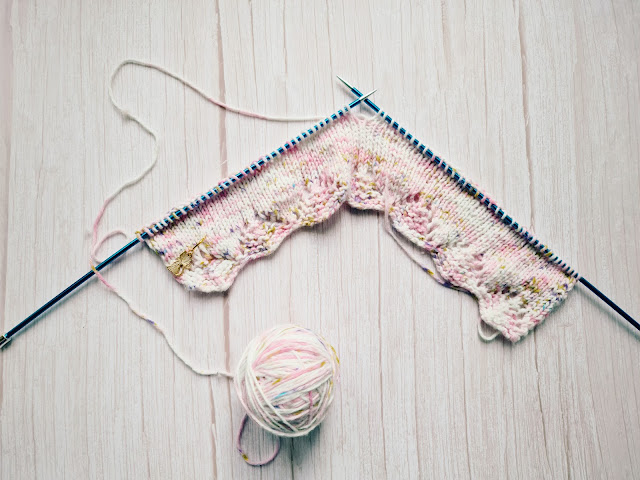 Flatlay of knitting and ball of yarn