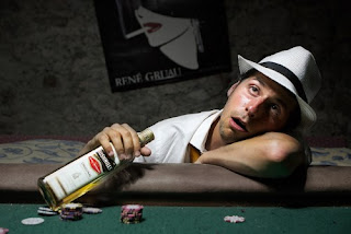 Poker player drunk at the table and staring at the ceiling.