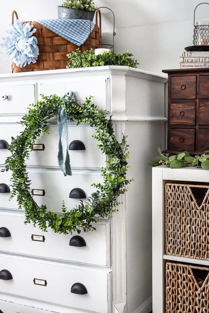 wreath on dresser, baskets, vintage decor