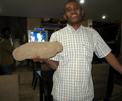 Turay shows me the difference between a yam and a sweet potato — about 5